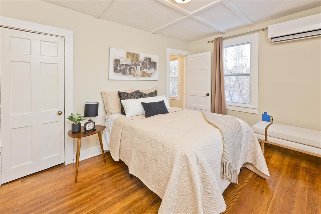 137 Old Amherst Road Belchertown, MA 01007 - Photo 15 of 42 a bedroom with a bed and wooden floor