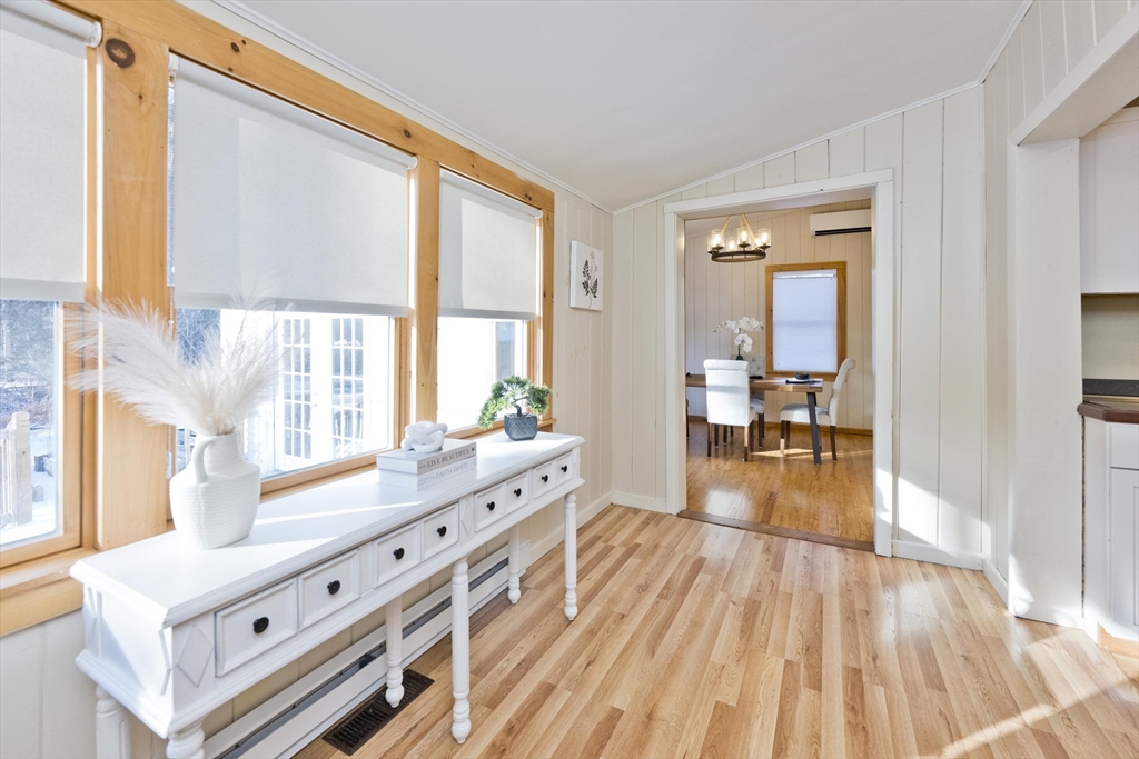 137 Old Amherst Road Belchertown, MA 01007 - Photo 23 of 42 a large living room with a large window wooden floor and chandelier