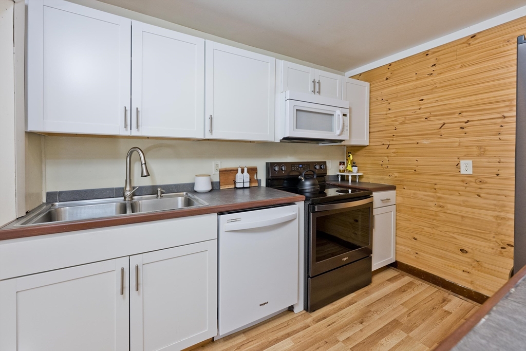 137 Old Amherst Road Belchertown, MA 01007 - Photo 25 of 42 a kitchen with stainless steel appliances granite countertop white cabinets stove a sink and dishwasher