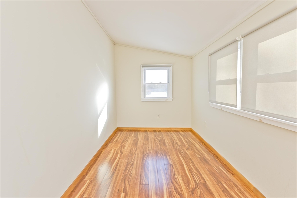 137 Old Amherst Road Belchertown, MA 01007 - Photo 28 of 42 an empty room with wooden floor and windows