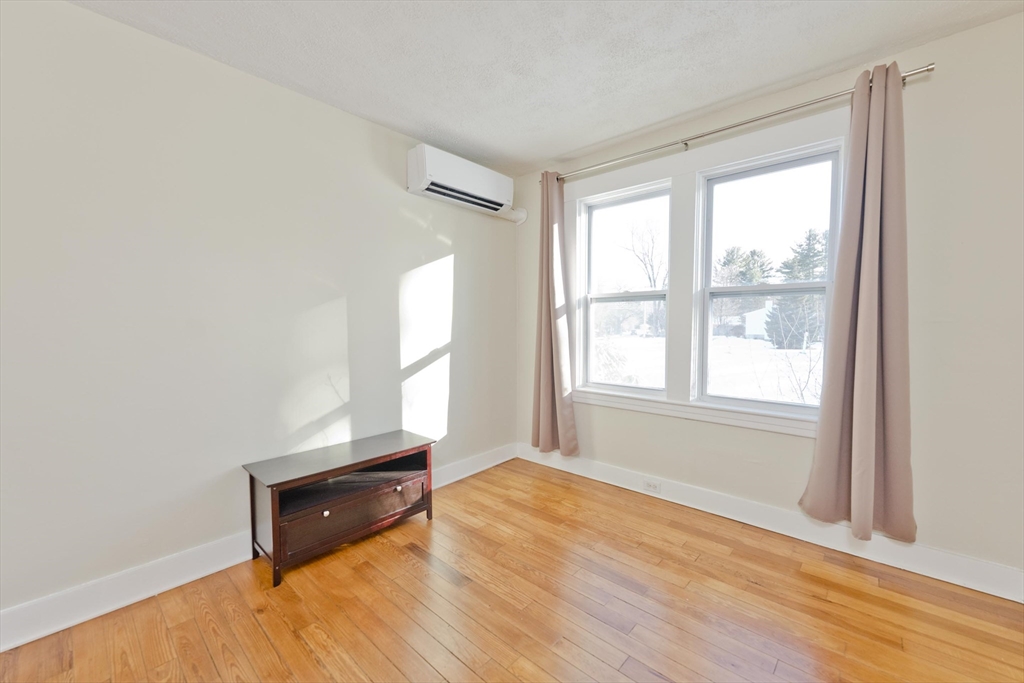 137 Old Amherst Road Belchertown, MA 01007 - Photo 30 of 42 an empty room with wooden floor and windows
