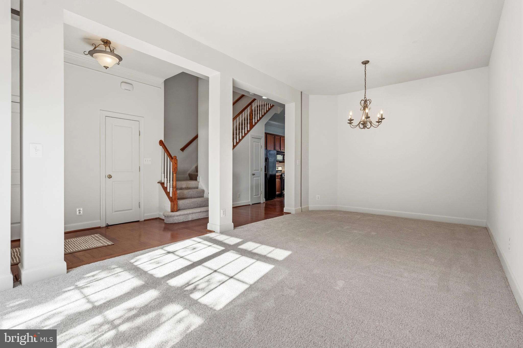 9227 Ribbon Falls Loop Bristow, VA 20136 - Photo 14 of 53 a view of a livingroom with wooden floor and staircase