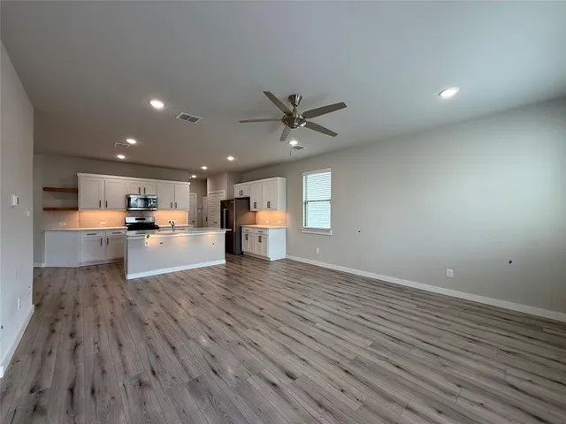 a view of kitchen with sink and wooden floor