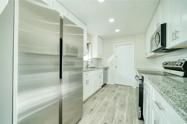 an aerial view of a house with garden space and street view