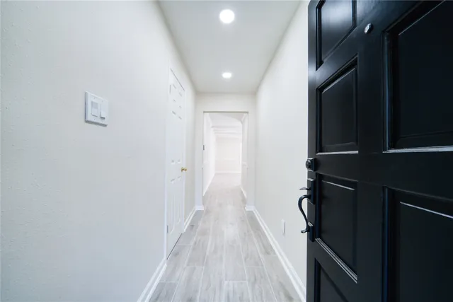 a view of hallway with wooden floor