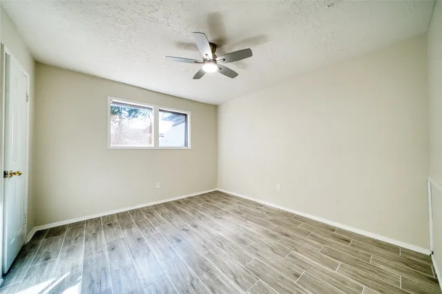 a bathroom with a granite countertop toilet and a sink