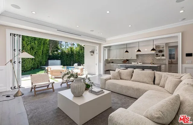 a kitchen with stainless steel appliances granite countertop a sink a stove and a wooden floors