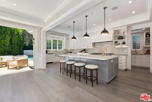 a kitchen with stainless steel appliances granite countertop a stove and a wooden floors