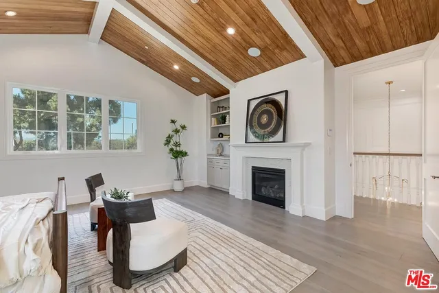 a view of a hallway with wooden floor and stairs
