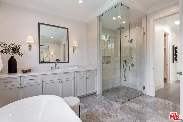 a living room with furniture a fireplace and a large window