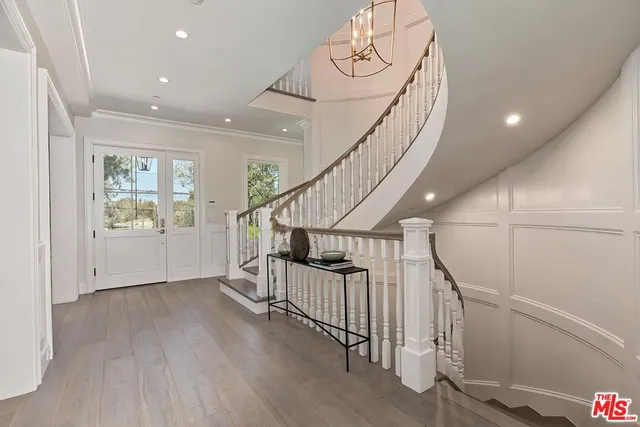 a living room with furniture a chandelier and a fireplace