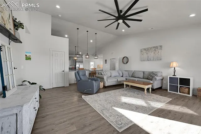 a kitchen with kitchen island granite countertop a sink cabinets and wooden floor