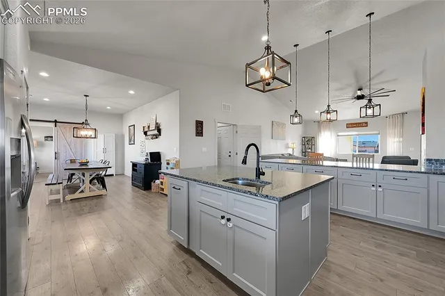 a spacious bedroom with a bed a window and a chandelier