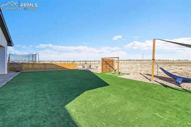 an aerial view of a house with a yard and ocean view