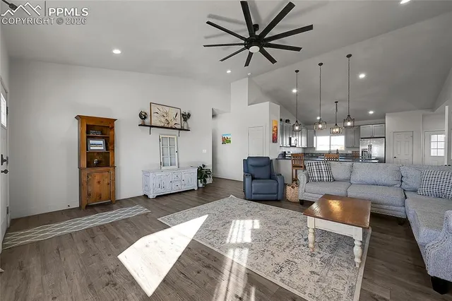 a kitchen with stainless steel appliances granite countertop a sink dishwasher and white cabinets with wooden floor