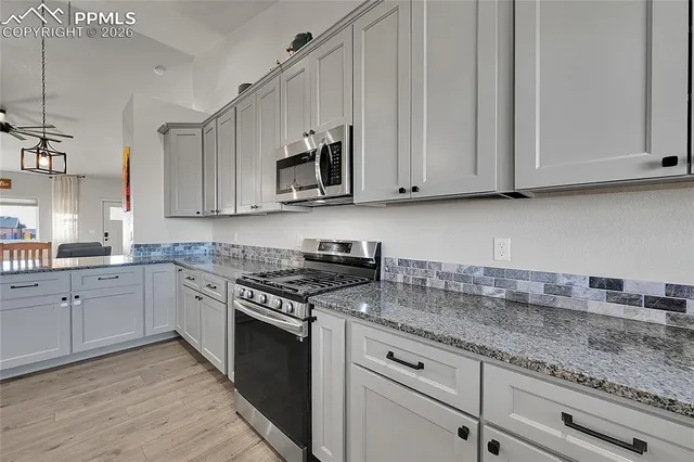 a view of a dining room with furniture wooden floor and a chandelier