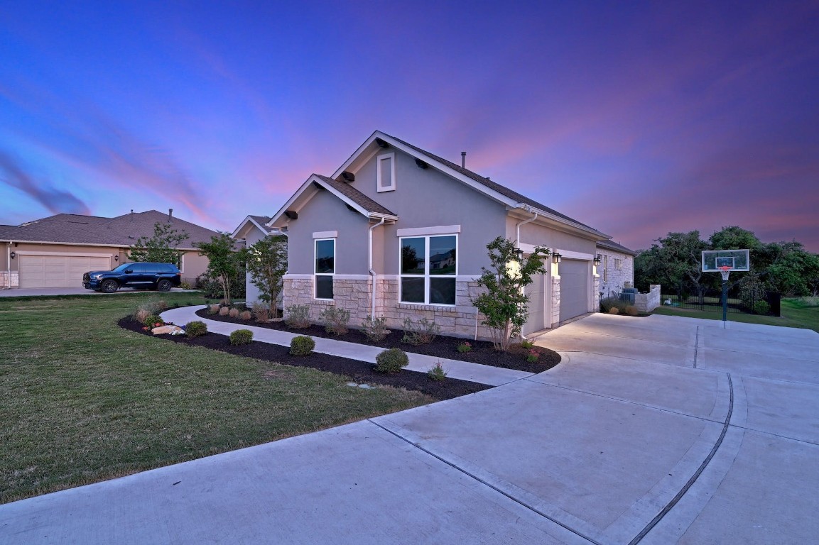 a front view of a house with a garden and yard