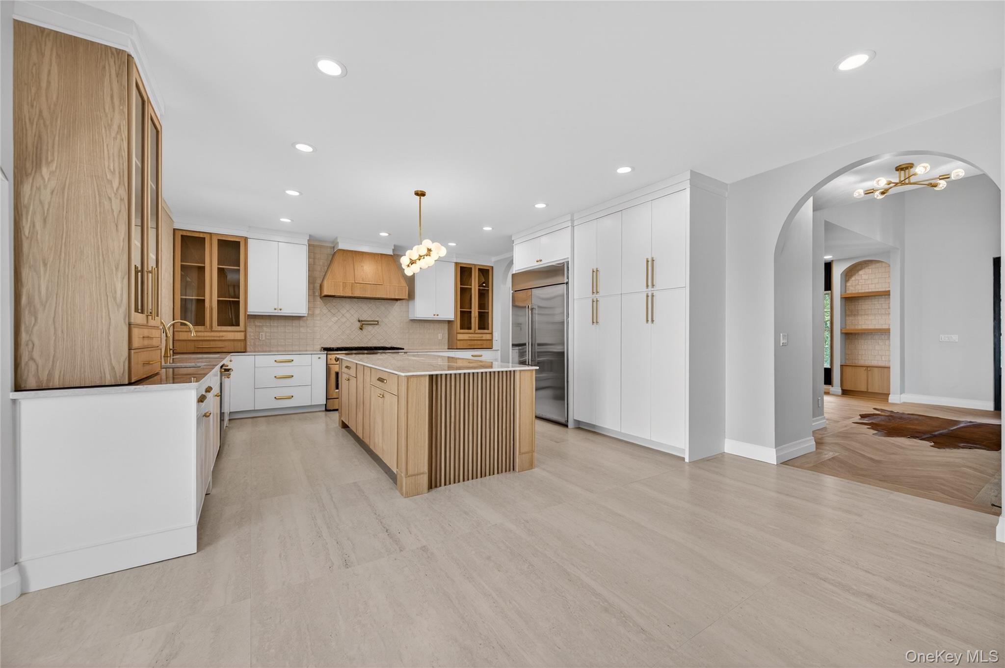15 Ridge Drive Port Washington, NY 11050 - Photo 13 of 46 a large kitchen with a lot of cabinets and refrigerator