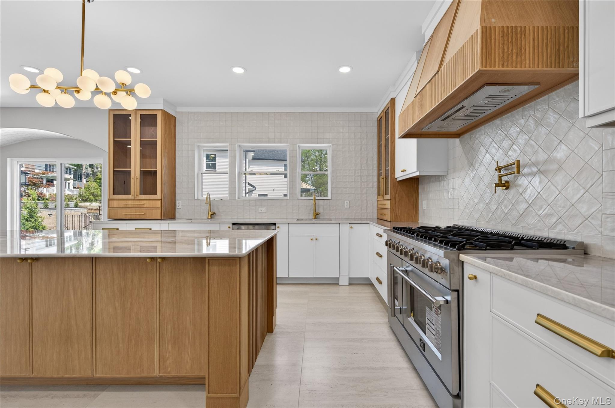 15 Ridge Drive Port Washington, NY 11050 - Photo 14 of 46 a kitchen with granite countertop a stove and a sink