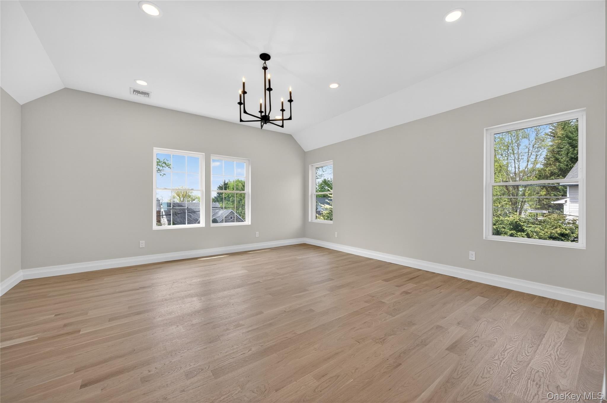 15 Ridge Drive Port Washington, NY 11050 - Photo 23 of 46 an empty room with wooden floor and windows