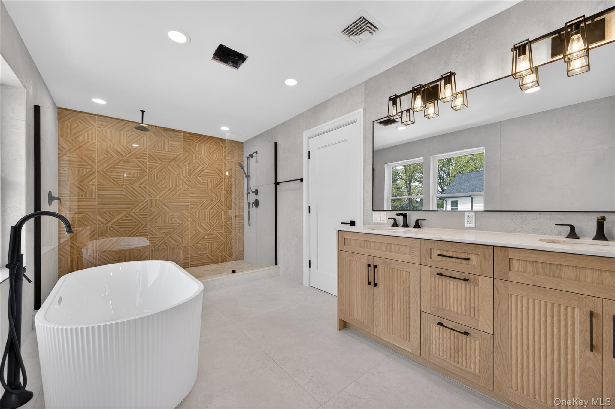 15 Ridge Drive Port Washington, NY 11050 - Photo 25 of 46 a large bathroom with a granite countertop sink a toilet a mirror and shower