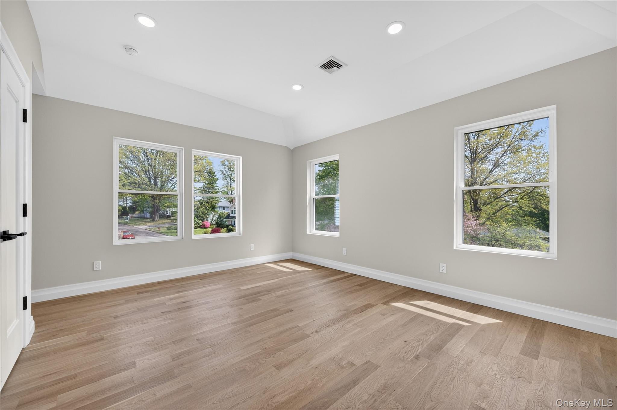 15 Ridge Drive Port Washington, NY 11050 - Photo 29 of 46 an empty room with wooden floor and windows