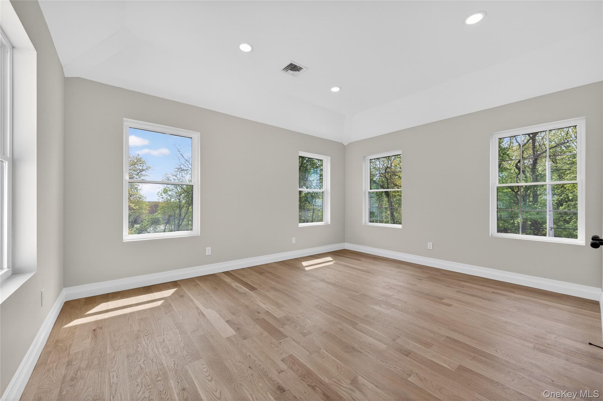 15 Ridge Drive Port Washington, NY 11050 - Photo 31 of 46 a view of empty room with wooden floor and fan