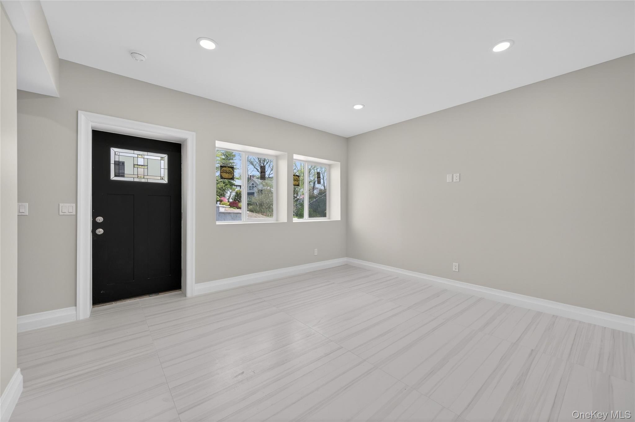 15 Ridge Drive Port Washington, NY 11050 - Photo 39 of 46 a view of an empty room with window and wooden floor