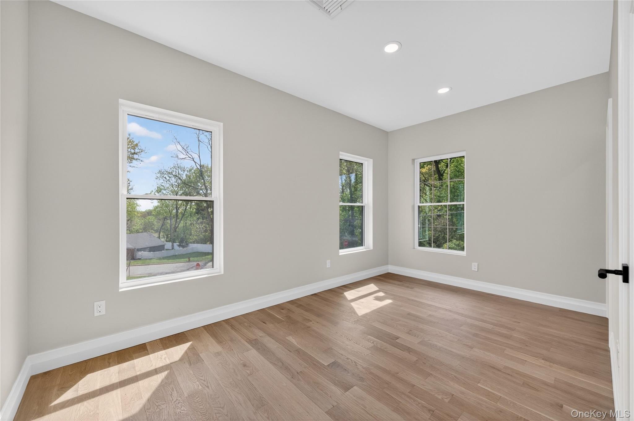15 Ridge Drive Port Washington, NY 11050 - Photo 40 of 46 a view of an empty room with wooden floor and a window