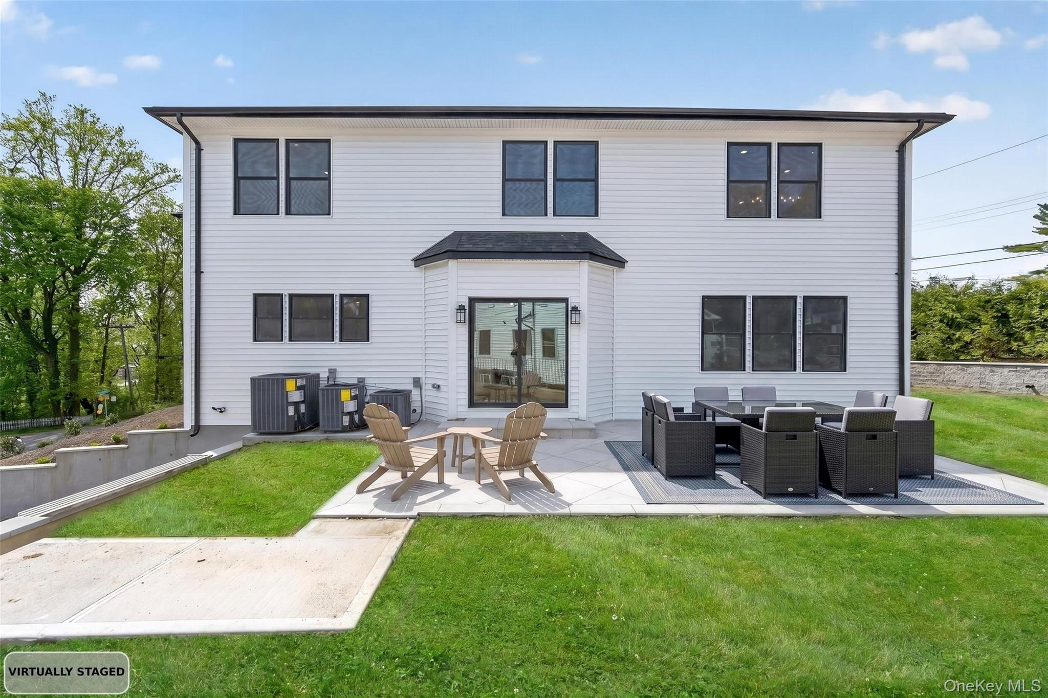 15 Ridge Drive Port Washington, NY 11050 - Photo 42 of 46 a view of a house with backyard sitting area and garden