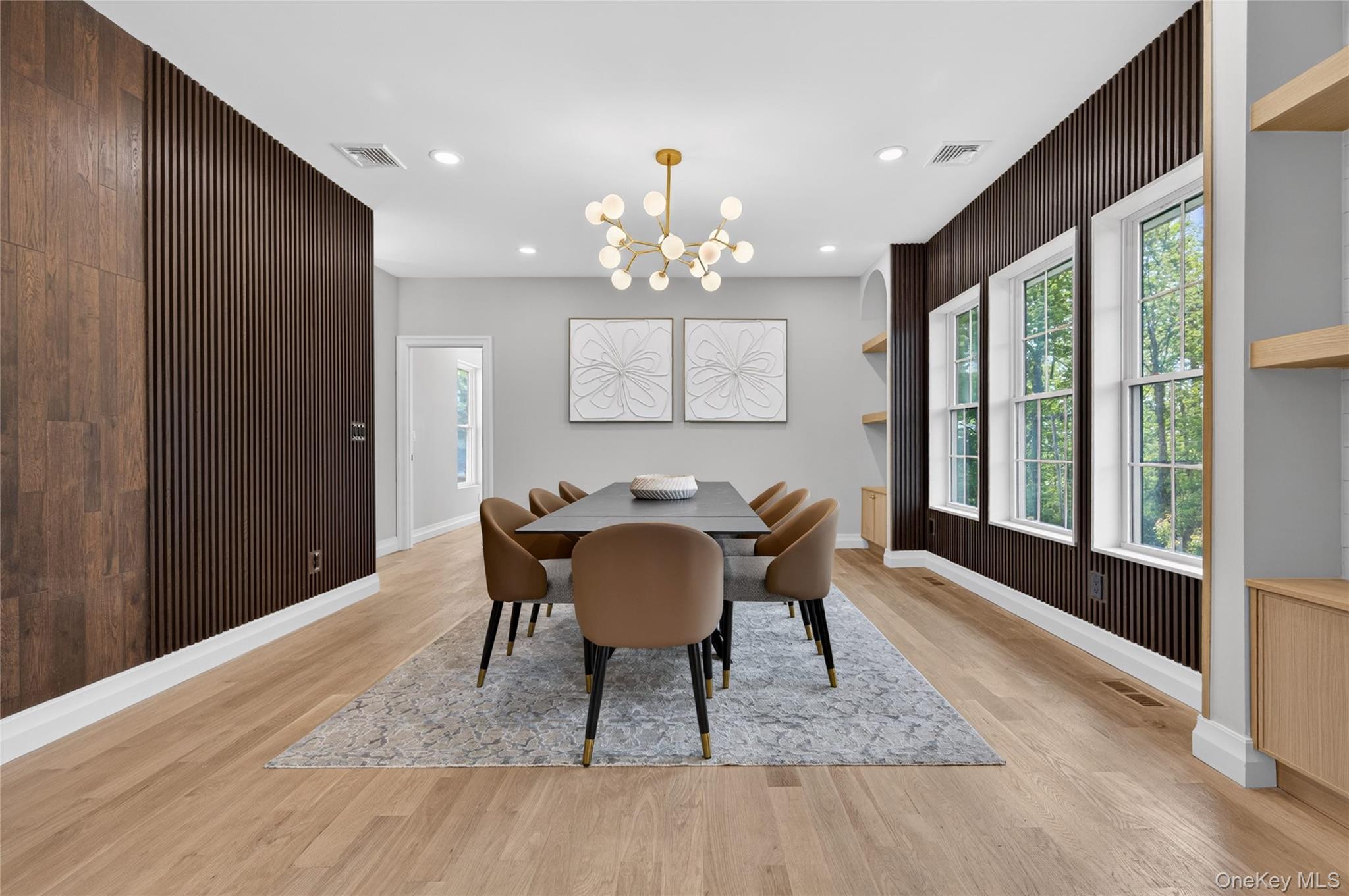15 Ridge Drive Port Washington, NY 11050 - Photo 7 of 46 a view of a dining room with furniture a chandelier and wooden floor