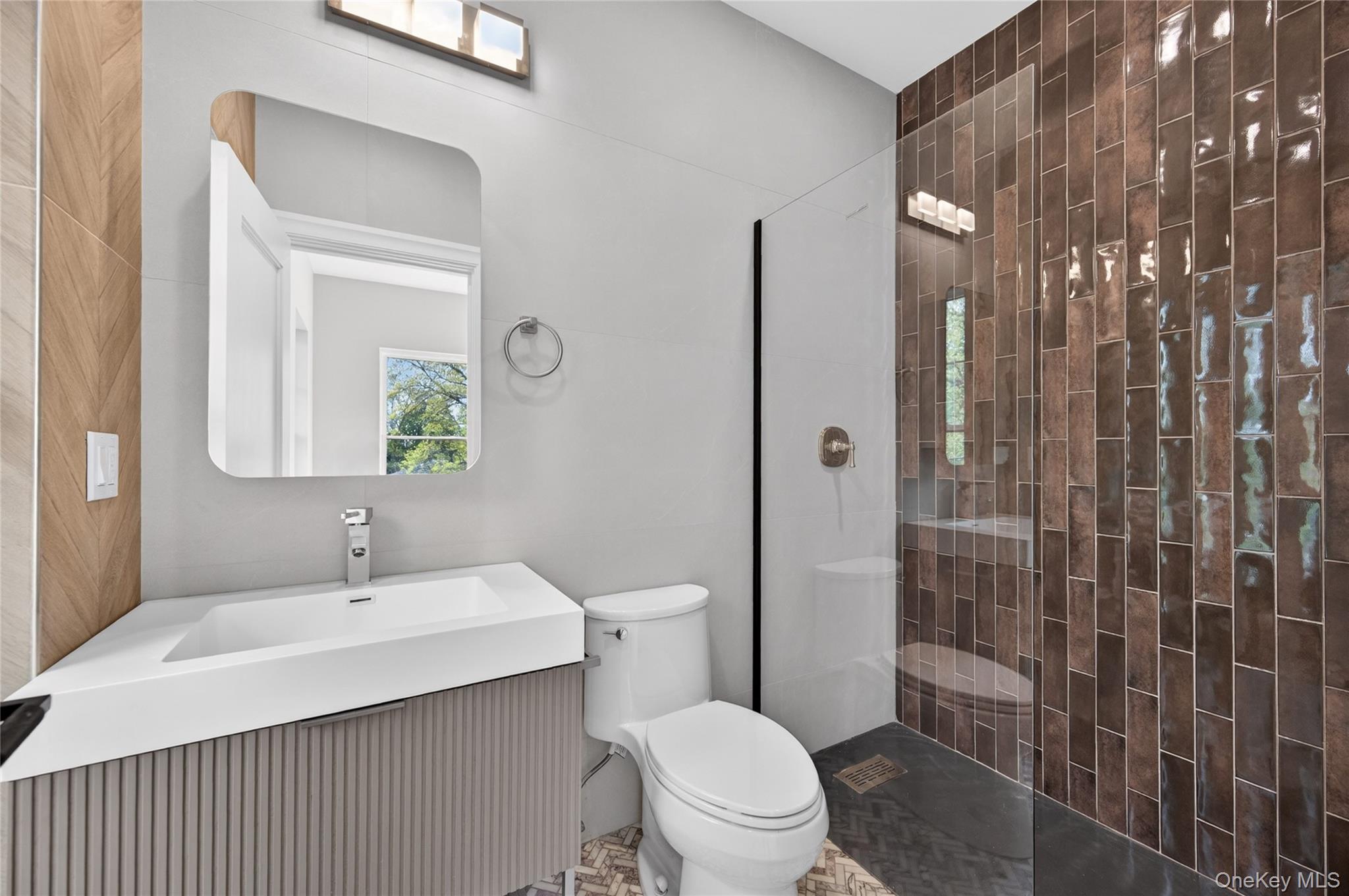 15 Ridge Drive Port Washington, NY 11050 - Photo 9 of 46 a bathroom with a sink toilet and shower