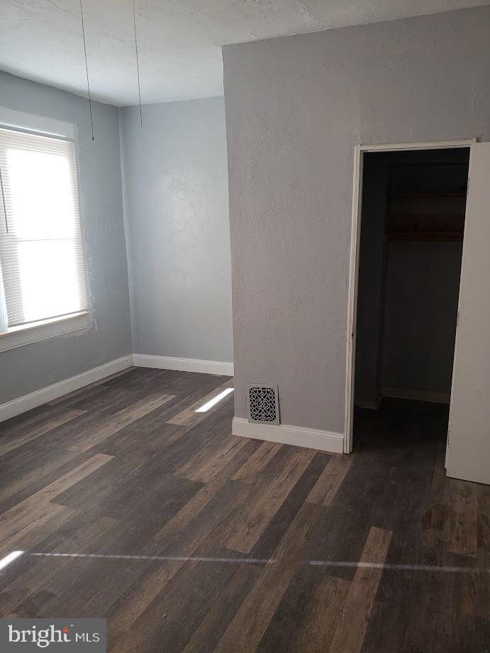 1111 West Colona Street Philadelphia, PA 19133 - Photo 2 of 6 an empty room with wooden floor and windows