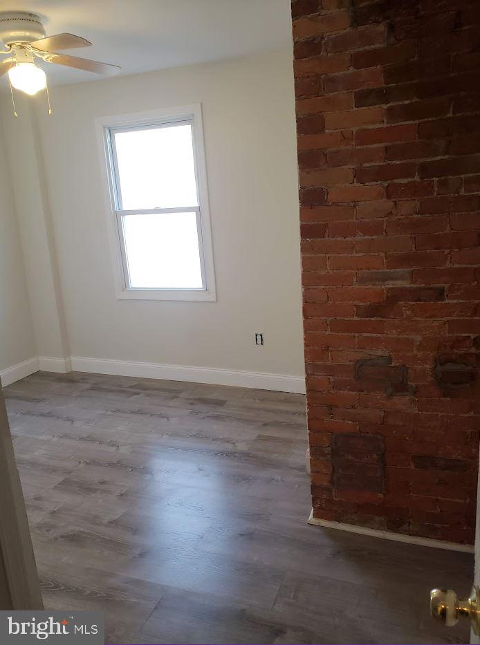 1111 West Colona Street Philadelphia, PA 19133 - Photo 5 of 6 an empty room with wooden floor and windows