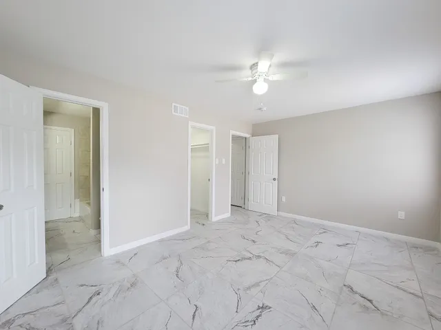 a view of an empty room with a fan