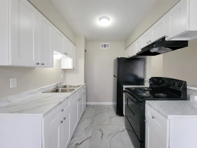 a kitchen with a stove and a refrigerator