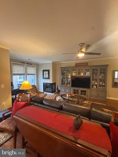 a living room with furniture pool and a flat screen tv