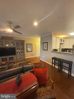 a kitchen with granite countertop a refrigerator and wooden cabinets
