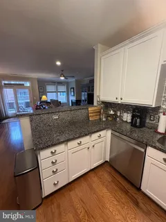 a bedroom with a large bed and a flat tv screen on dresser