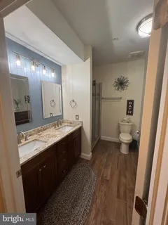 a room with wooden floors and cabinet