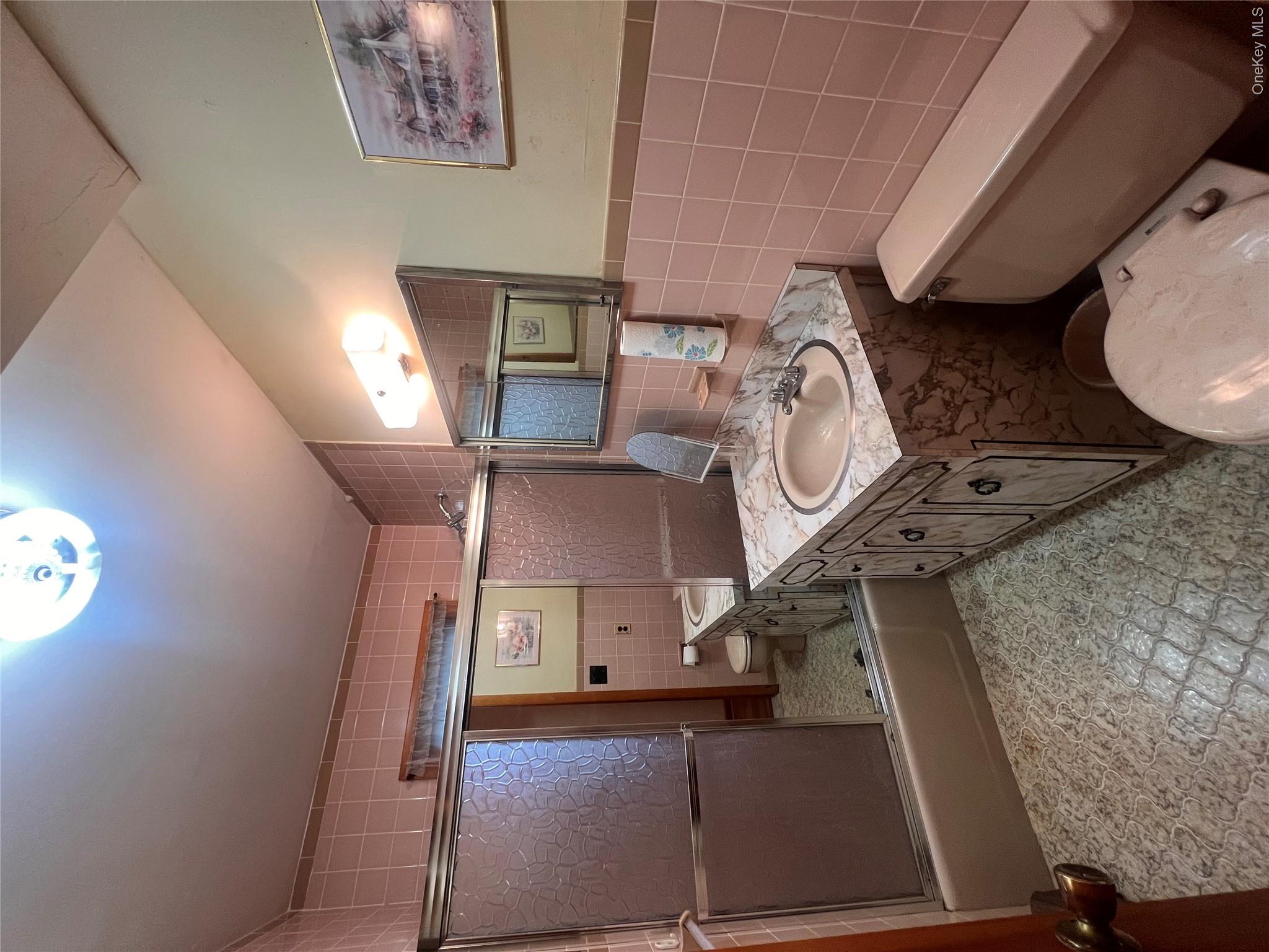 4 Beach Road, Unit G Glen Spey, NY 12737 - Photo 5 of 16 a bathroom with a sink a toilet and shower
