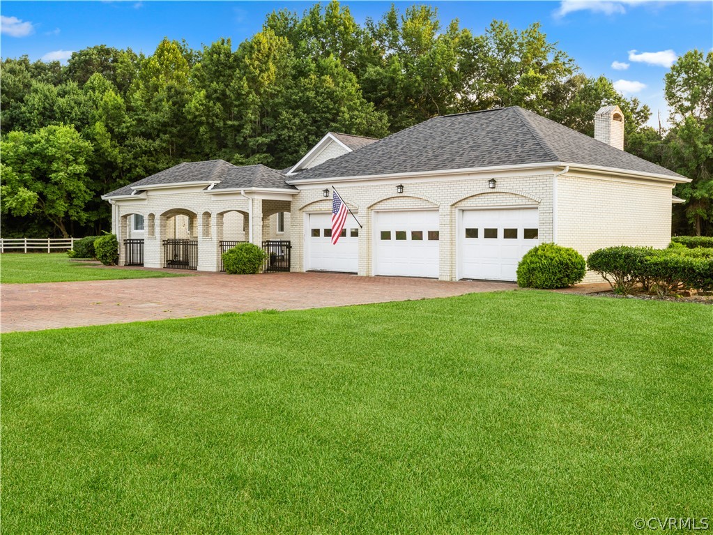 3906 Sharps Road Warsaw, VA 22572 - Photo 2 of 47 a front view of a house with a yard and garage