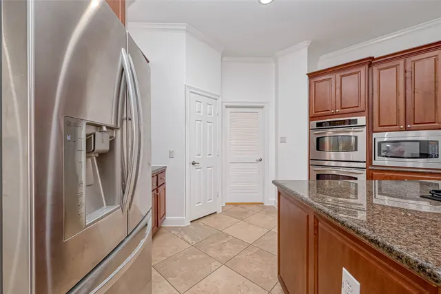 a kitchen with stainless steel appliances granite countertop a refrigerator and a stove