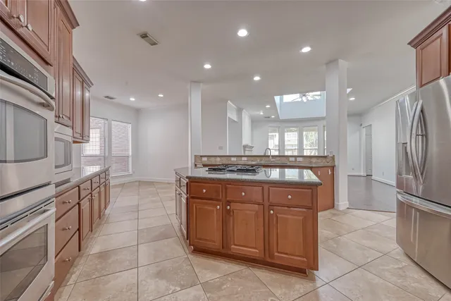 a kitchen with granite countertop a stove and a sink