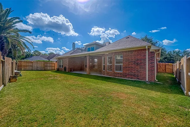 a view of a house with a backyard