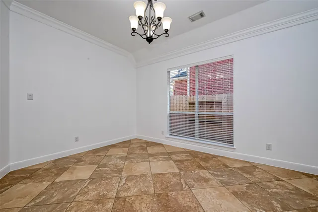 a view of an empty room with a chandelier