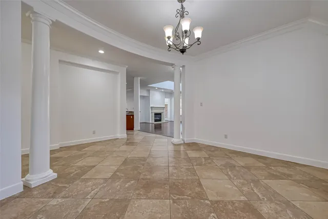 a view of an empty room with a chandelier