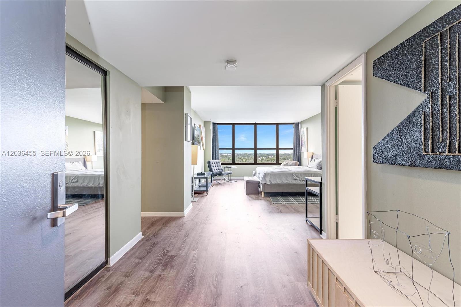 780 Northeast 69th Street, Unit 1010 Miami, FL 33138 - Photo 22 of 31 a bedroom with furniture and a wooden floor
