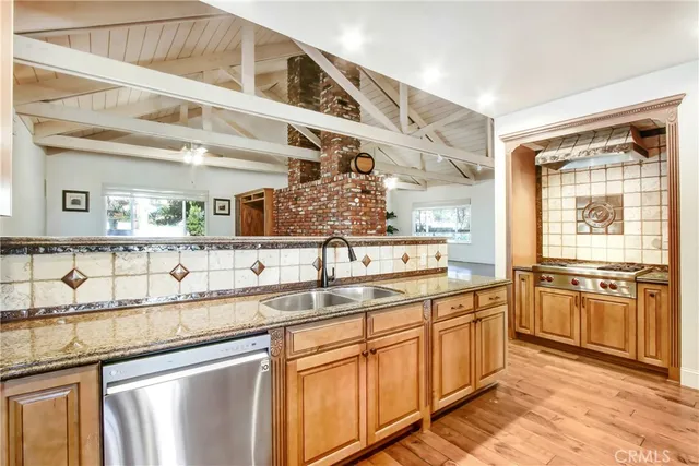 a kitchen with stainless steel appliances granite countertop a sink and cabinets