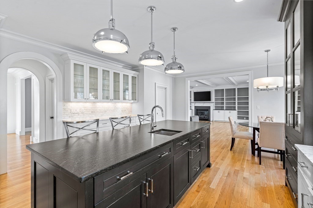 5 Cider Circle Bolton, MA 01740 - Photo 15 of 42 a kitchen with granite countertop a stove a sink a dining table and chairs
